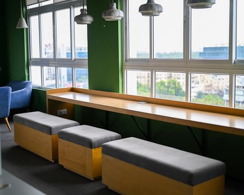 A modern educational hub setup inside a clean urban office with minimalist wood textures and bright lighting